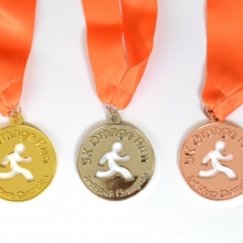 Set of custom winner race medals in glossy gold, silver and bronze finish