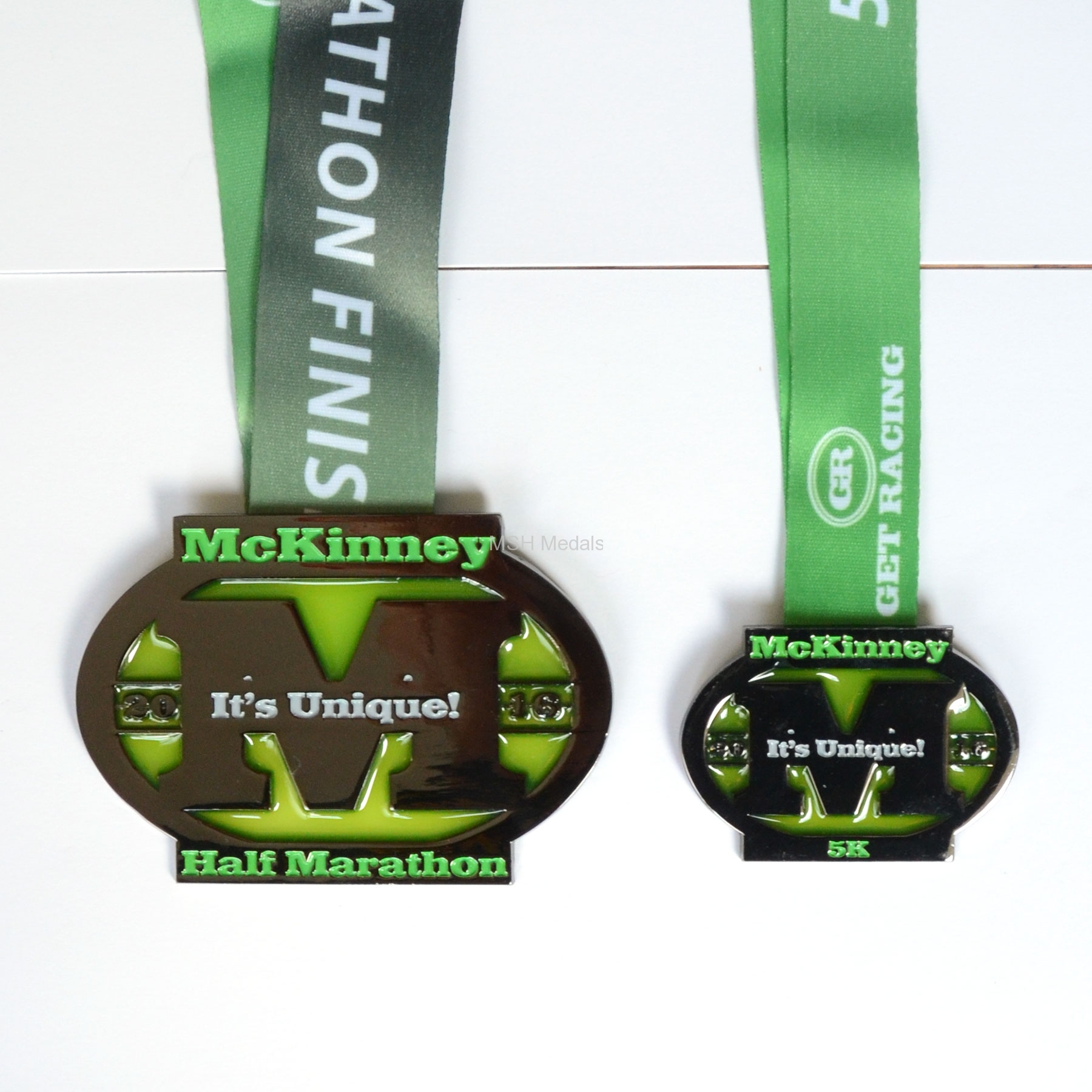 Set of 2 custom medals (5K and half marathon) in black dye finish and semi-transparent ink